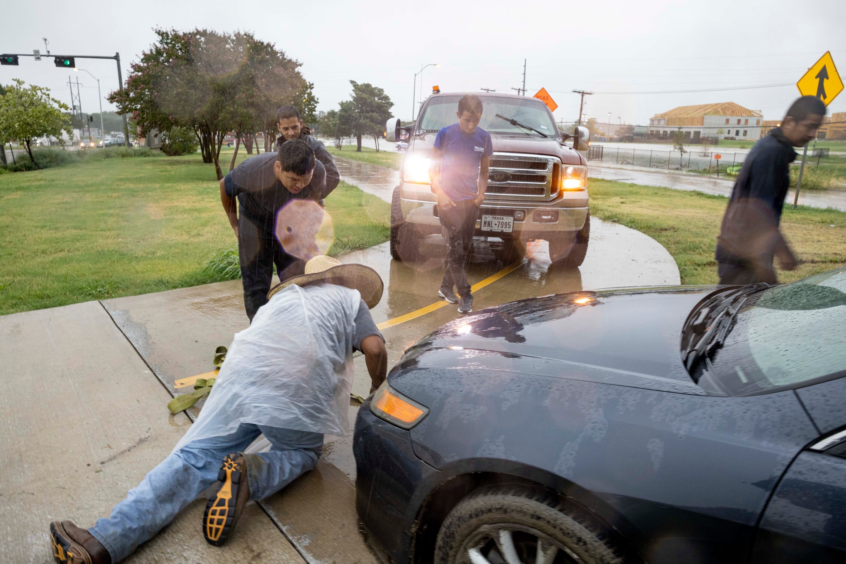 Daniel Vasquez (on the floor) with the help of his dad, brother and cousin get ready to pull...