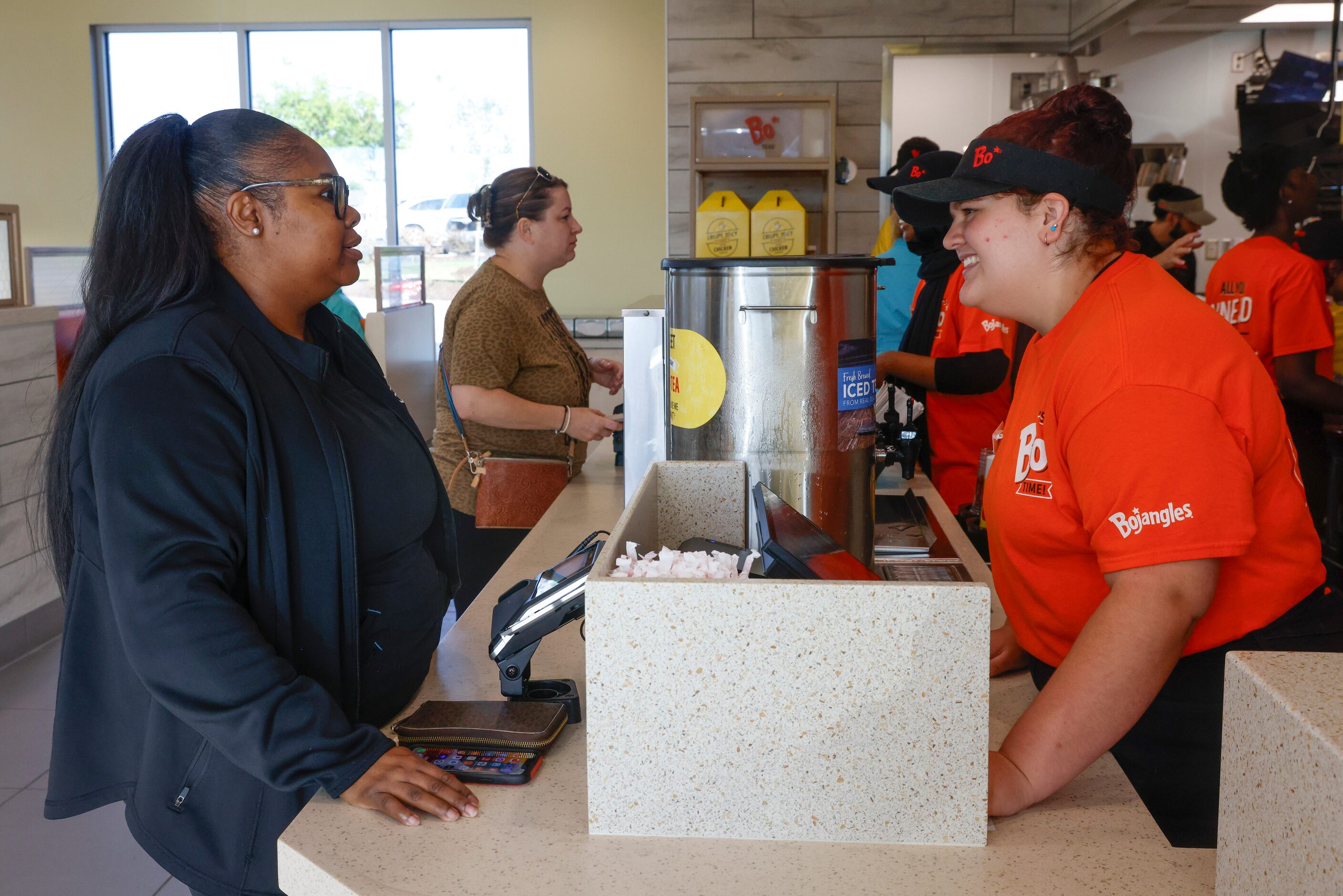 Samira Pervis (left) of North Carolina, talks to employee Dakota Prinz as Pervis orders her...