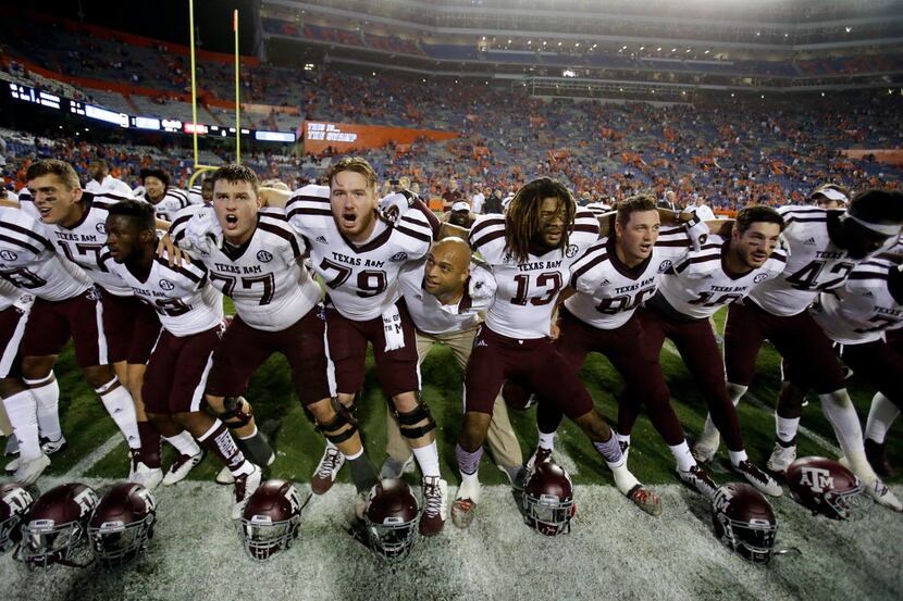 Texas A&M players sing and celebrate in front of fans after defeating Florida 19-17 in...