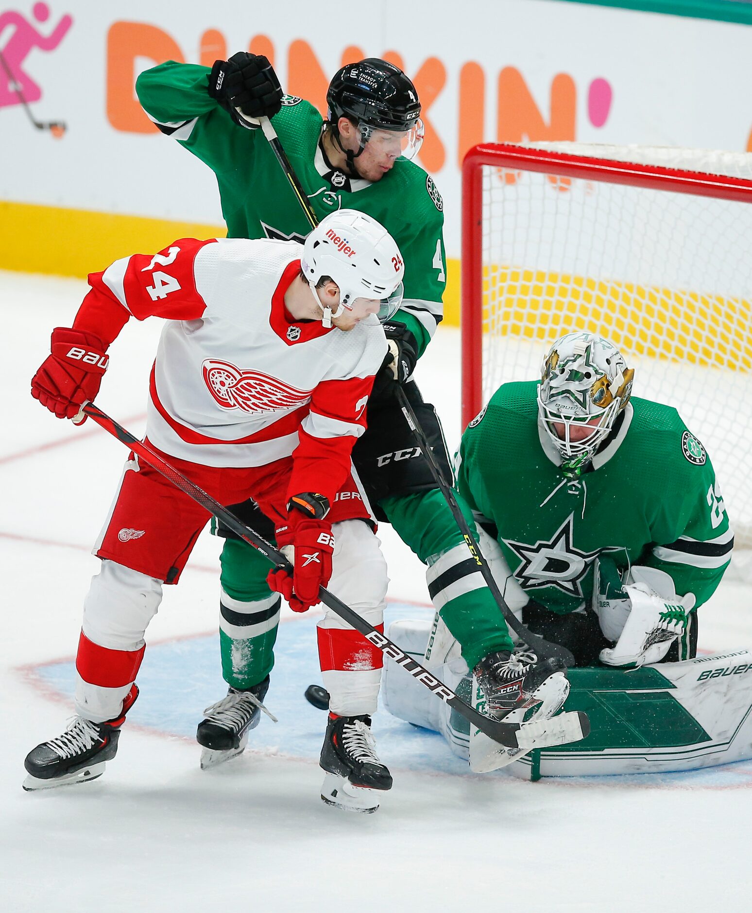 Detroit Red Wings forward Pius Suter (24) looks for a rebound as Dallas Stars defenseman...