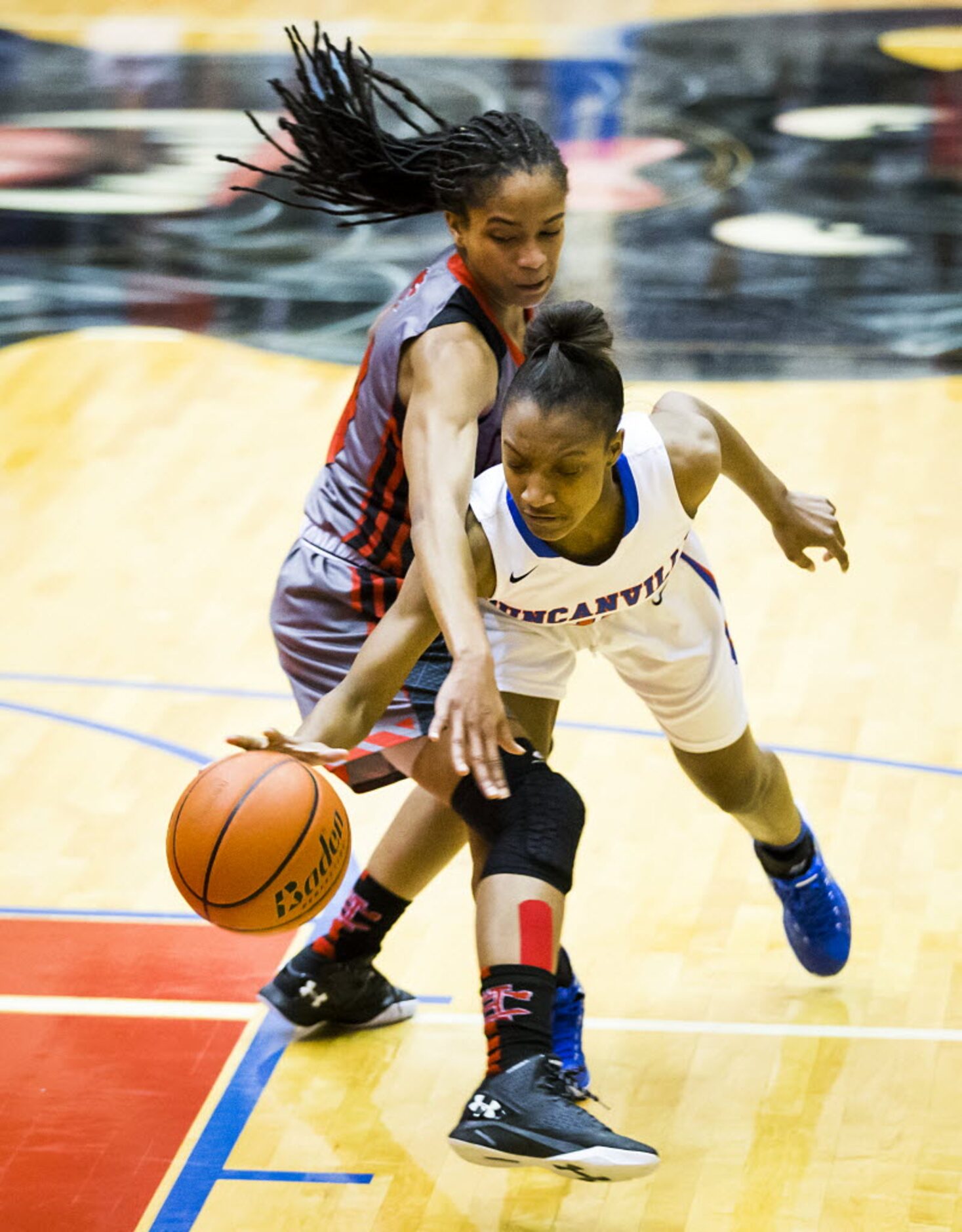 Duncanville guard Aniya Thomas (20) is fouled by Cedar Hill guard Victoria Jackson (10)...