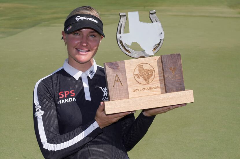 Charley Hull, of England, poses with the champion's trophy after winning the LPGA The...
