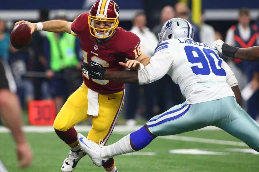 Washington Redskins quarterback Colt McCoy (16) is grabbed by Dallas Cowboys defensive end...