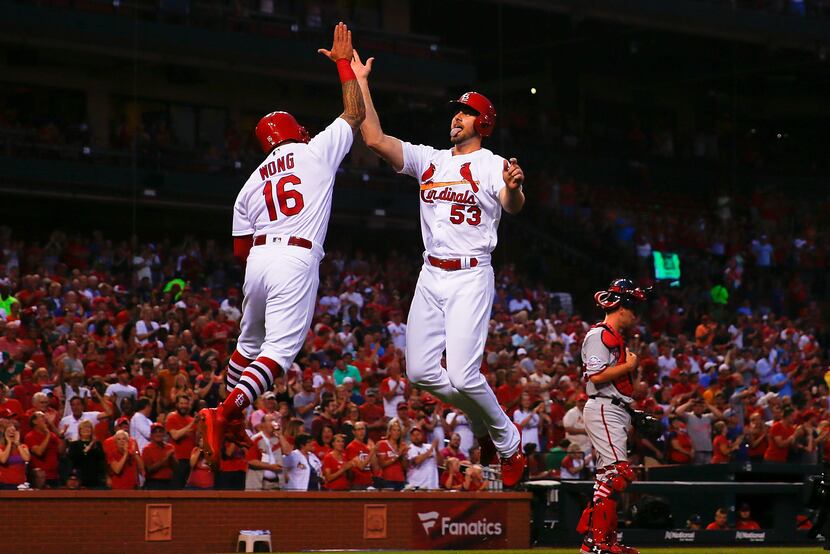 John Gant (right) of the St. Louis Cardinals celebrates after hitting a two-run home run...