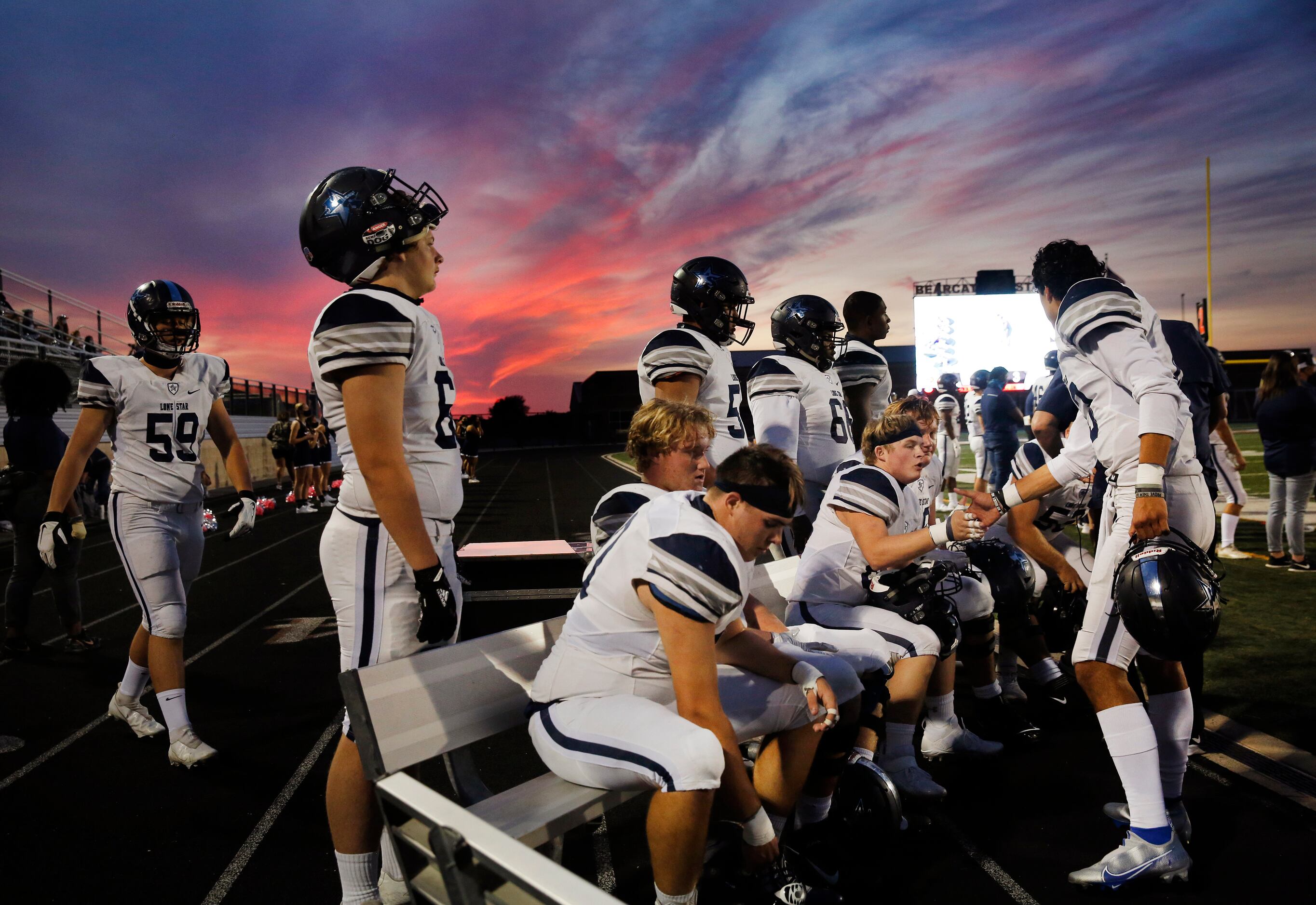 The sun sets behind the Frisco Lone Star bench as players catch their breath during the...
