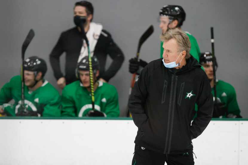 Dallas Stars head coach Rick Bowness watches his team workout during a training camp...