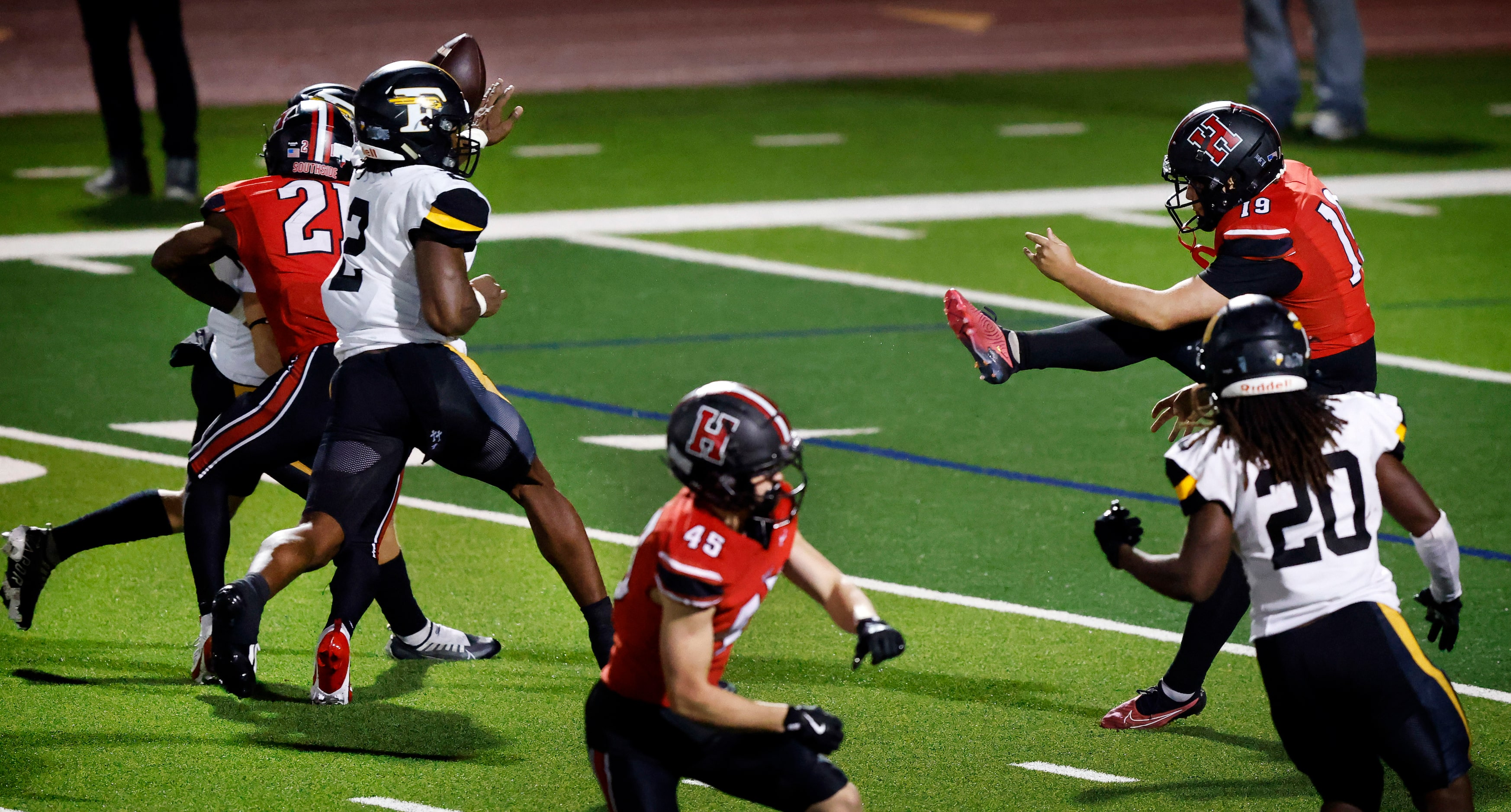 Forney linebacker Kelvion Riggins (2) blocks a punt by Rockwall-Heath’s Bronson
Mueller (47)...