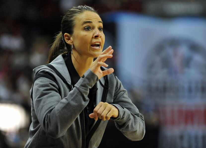 
 Coach Becky Hammon talks to a player on the floor during the NBA Summer League Final. 
