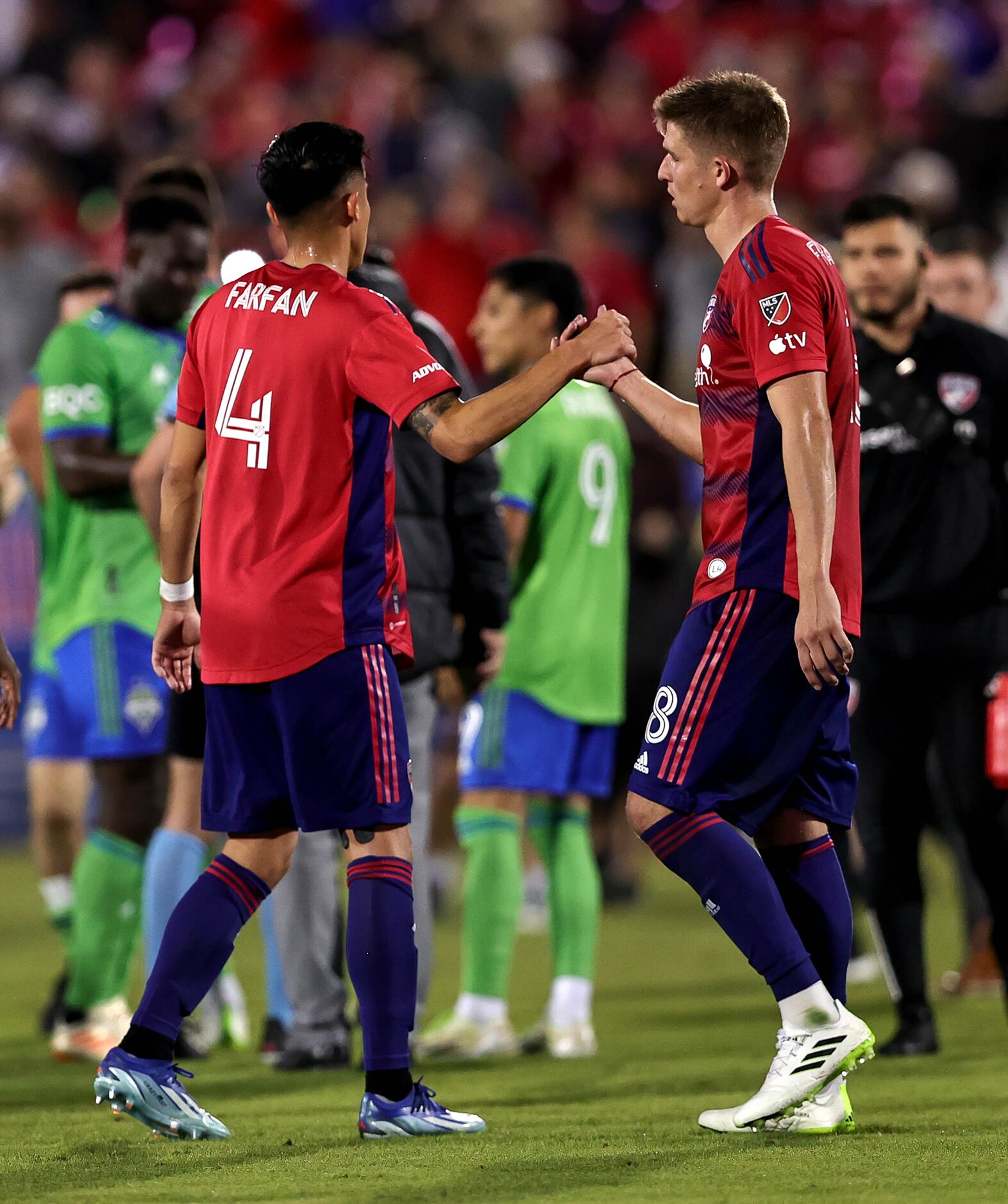 FC Dallas defender Marco Farfan (14) and midfielder Liam Fraser (18) celebrate their victory...