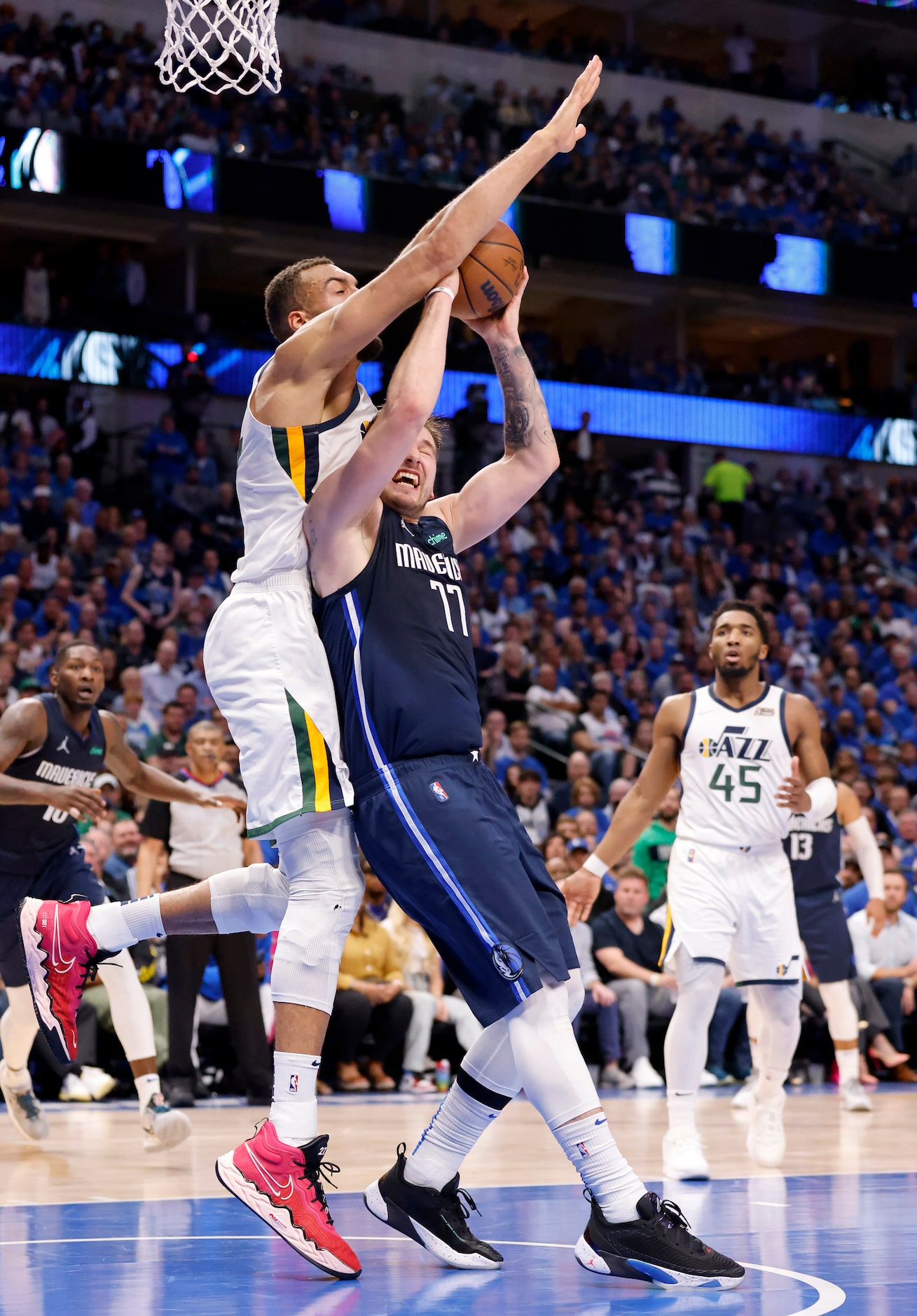 Dallas Mavericks guard Luka Doncic (77) puts up a blind shot as he’s fouled by Utah Jazz...