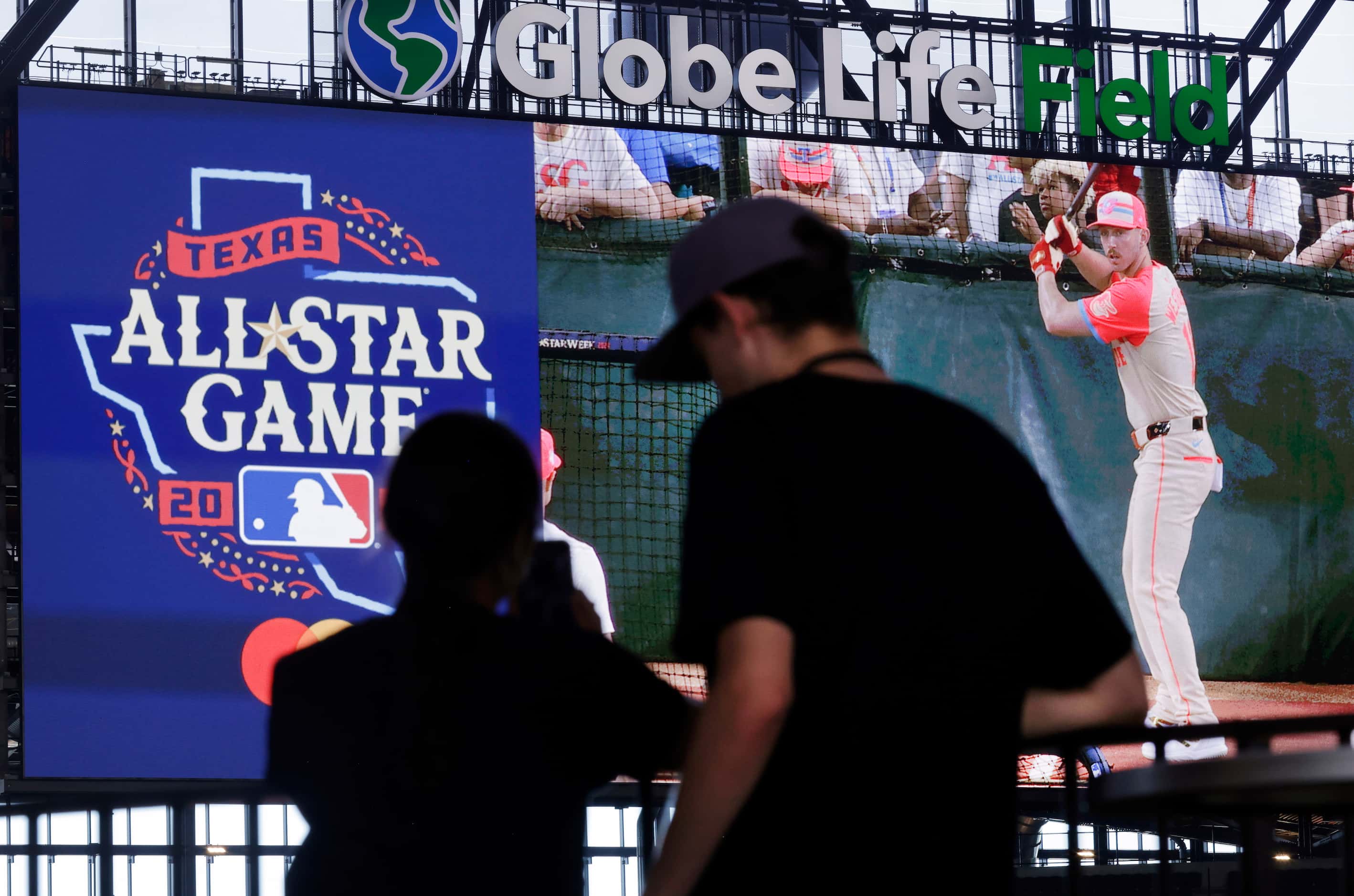 Baseball fans watch batting practice on main video board before the MLB All-Star Game at...