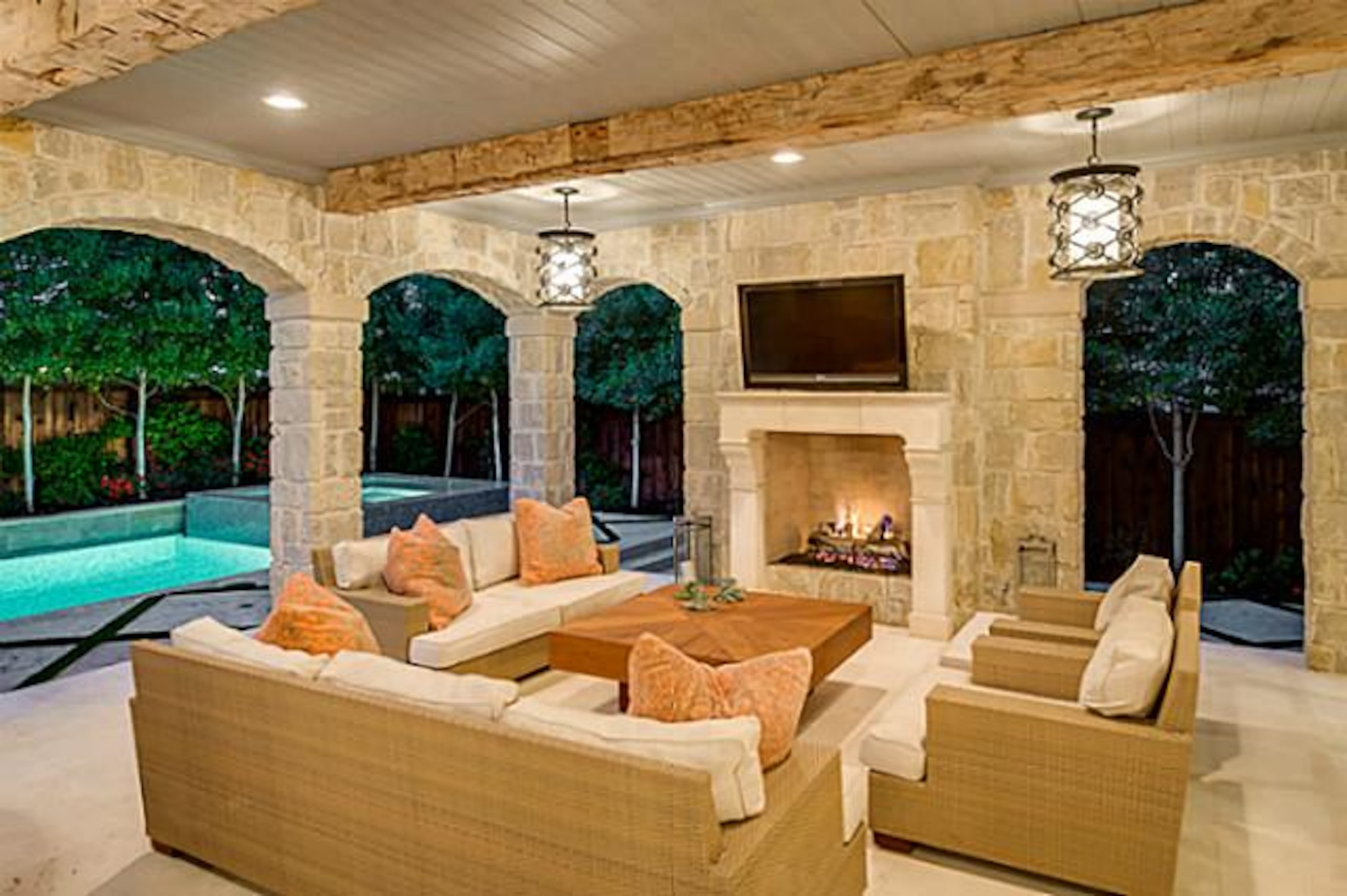 The outdoor environment room has grilling necessities and a fireplace.