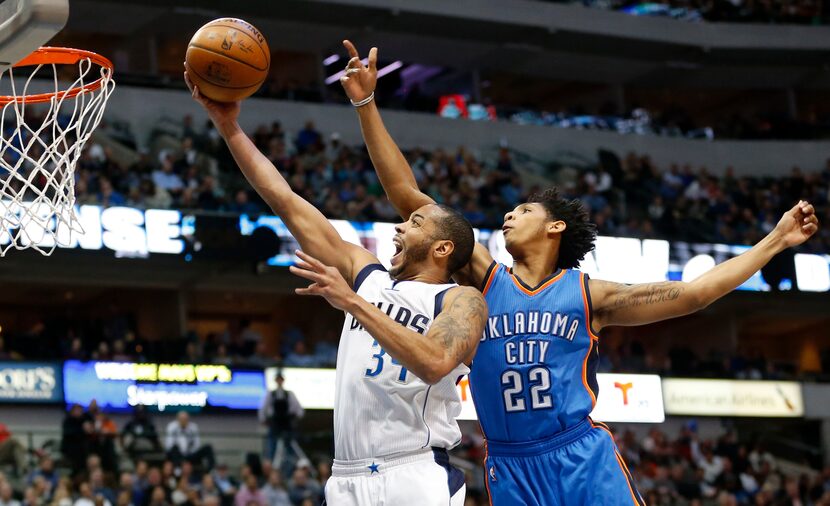 Mavericks guard Devin Harris (34) attempts a shot in front of Oklahoma City Thunder guard...