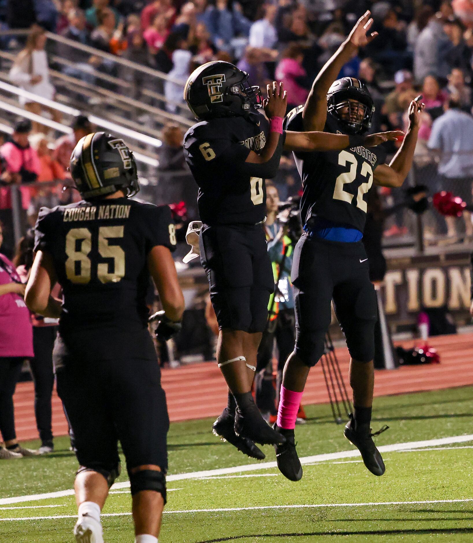 The Colony players celebrate a touchdown during the first half of a District 5-5A Division I...