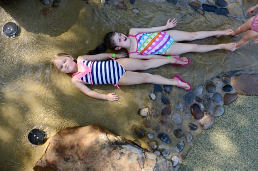 Zoey Wilson, 5, (top) and Ava Bannister, 5, soak up nature in the simulated trail bed at the...
