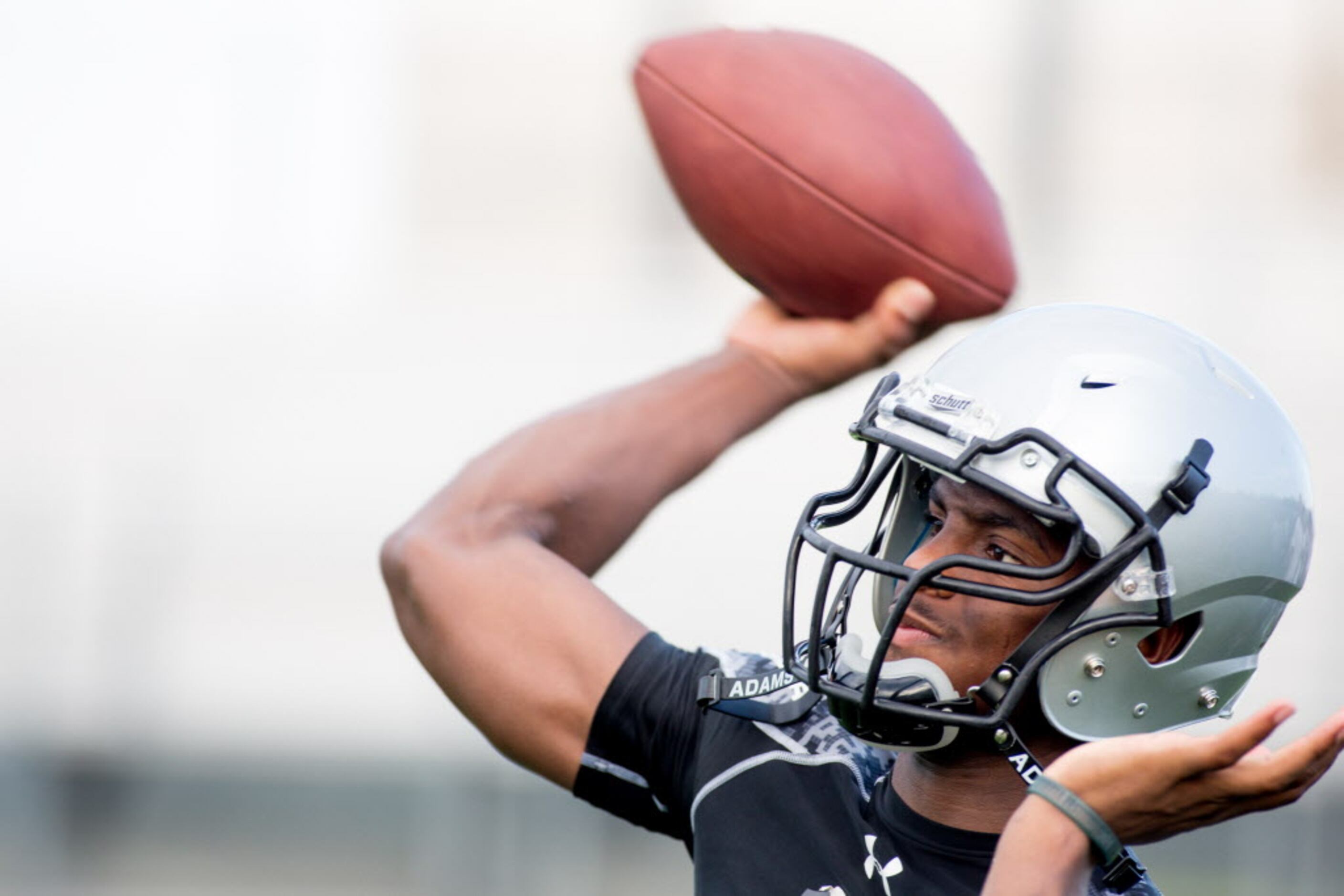Sophomore QB Shawn Robinson throws a pass during the first day of two-a-days at Denton Guyer...