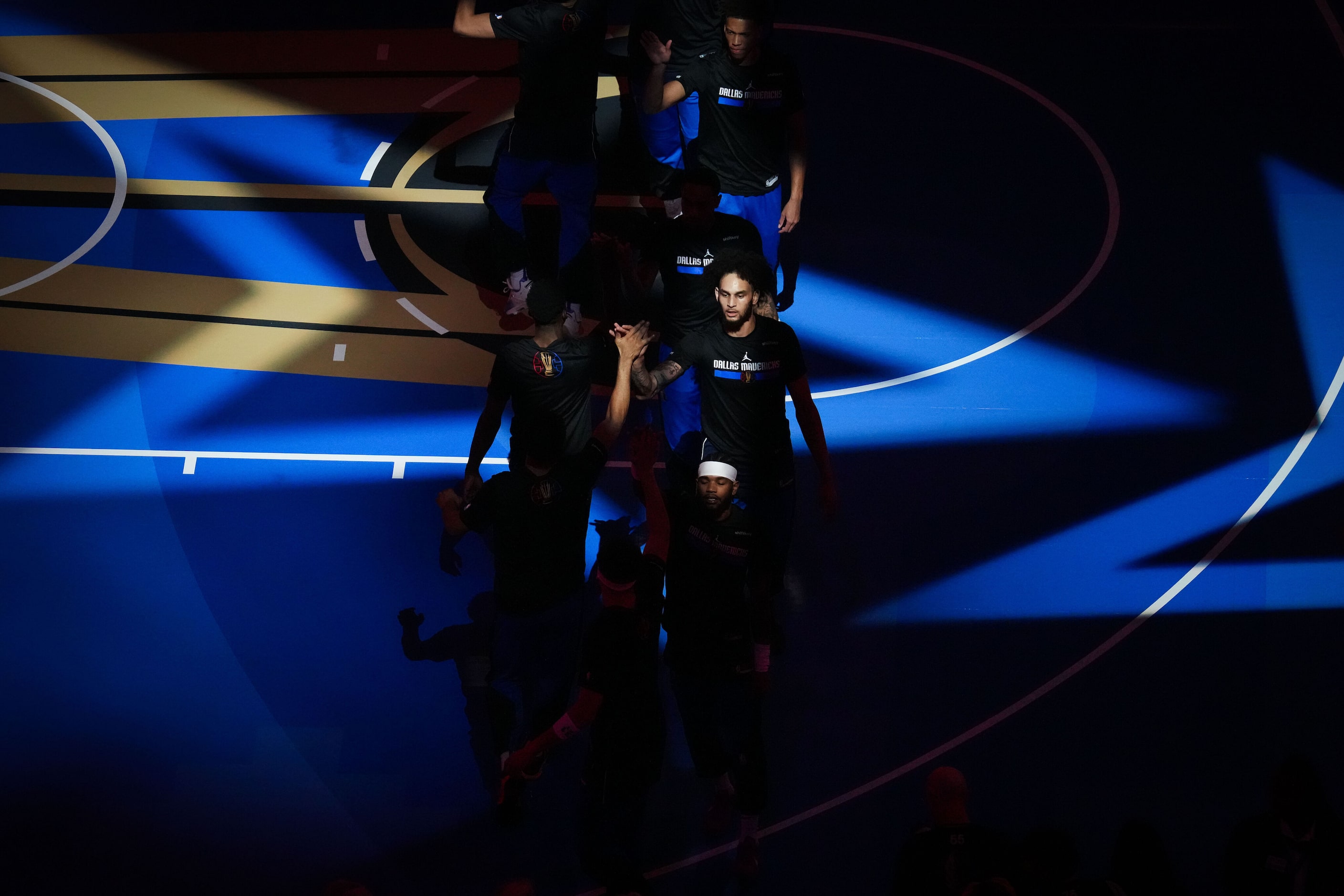 Dallas Mavericks center Dereck Lively II high fives teammates before an NBA basketball game...