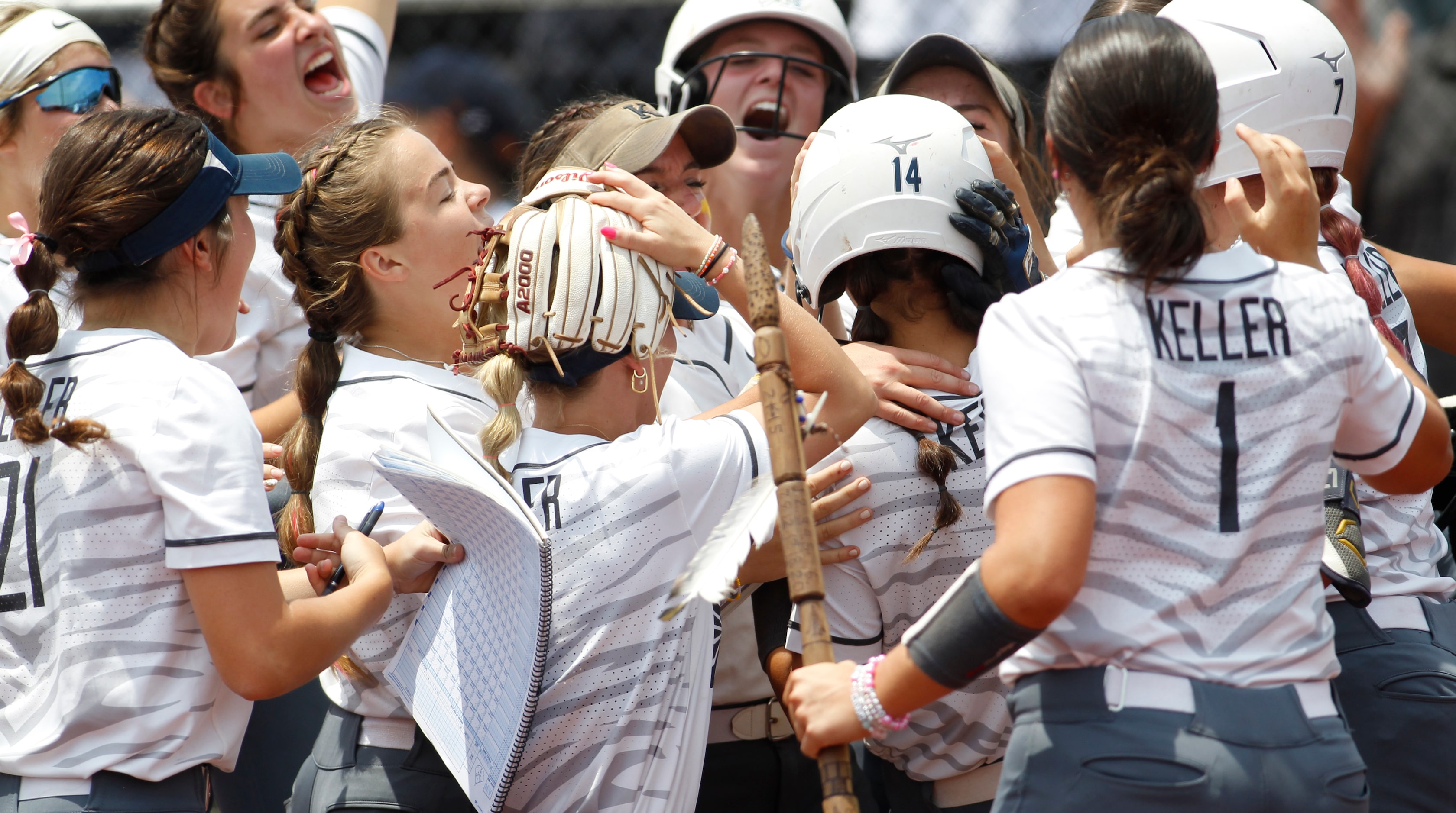 Keller's Kaiya Fabela (14) is mobbed by teammates after hitting a two run home run during...