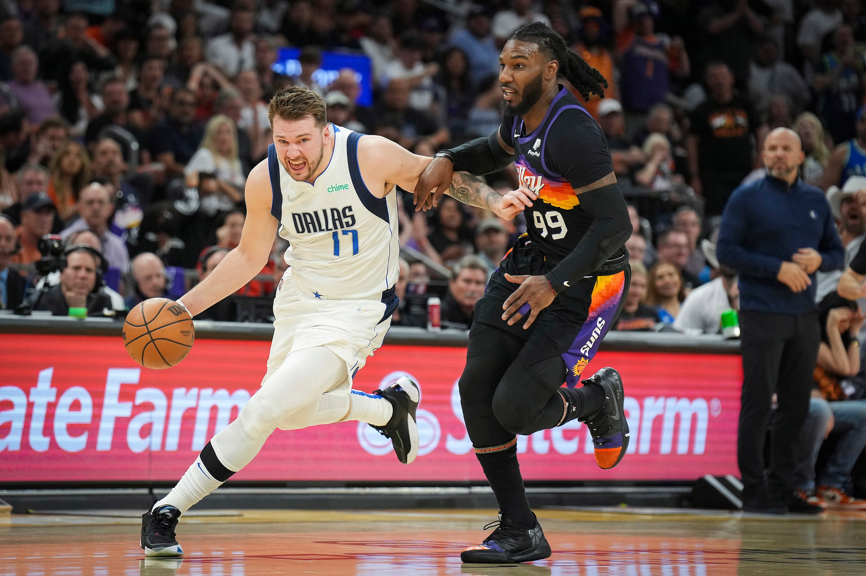 Dallas Mavericks guard Luka Doncic (77) dribbles past Phoenix Suns forward Jae Crowder (99)...