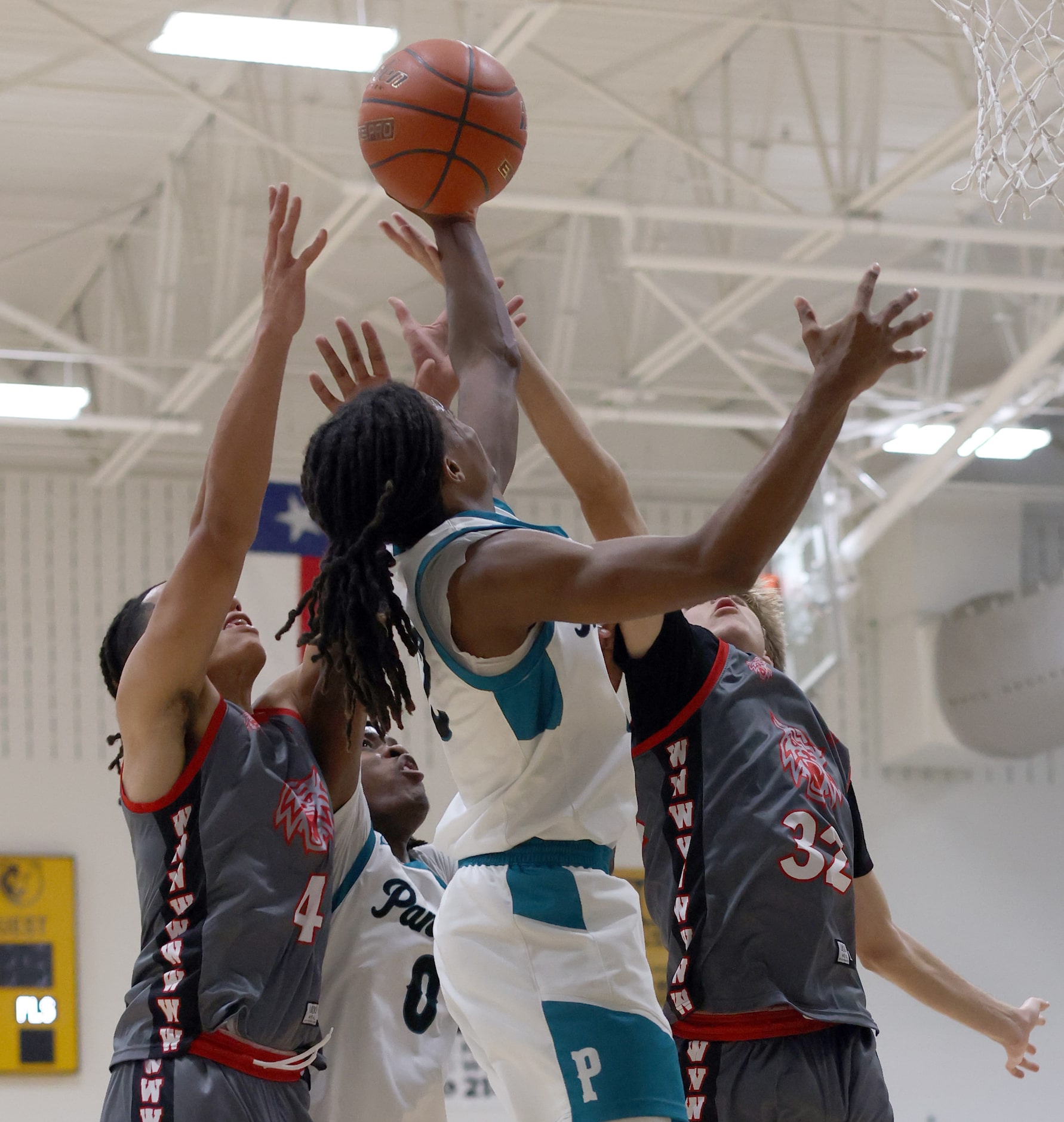 Frisco Panther Creek's Sabien McGraw (12), center, wins the rebound battle over teammate...