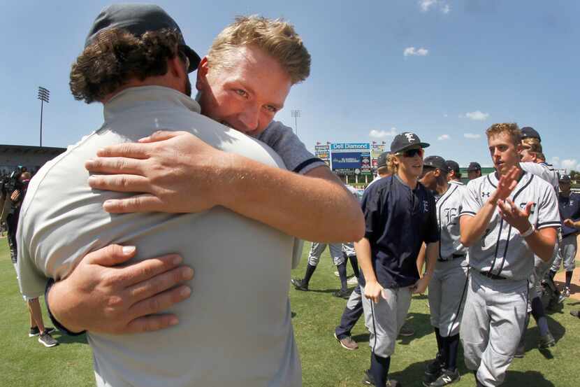 Northwest Eaton pitcher Riley Taylor (28) hugs head coach Jeremy Fatheree at the conclusion...