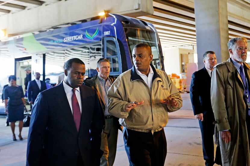 U.S. Secretary of Transportation Anthony Foxx, right, talks with Atlanta Mayor Kasim Reed,...