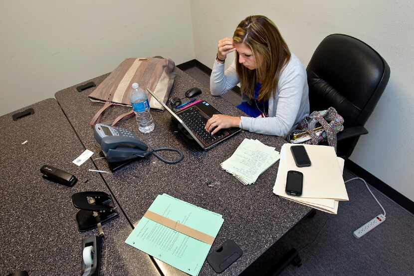 CPS Master Investigator, Ashley Depeaux, goes over paperwork at the Texas Department of...