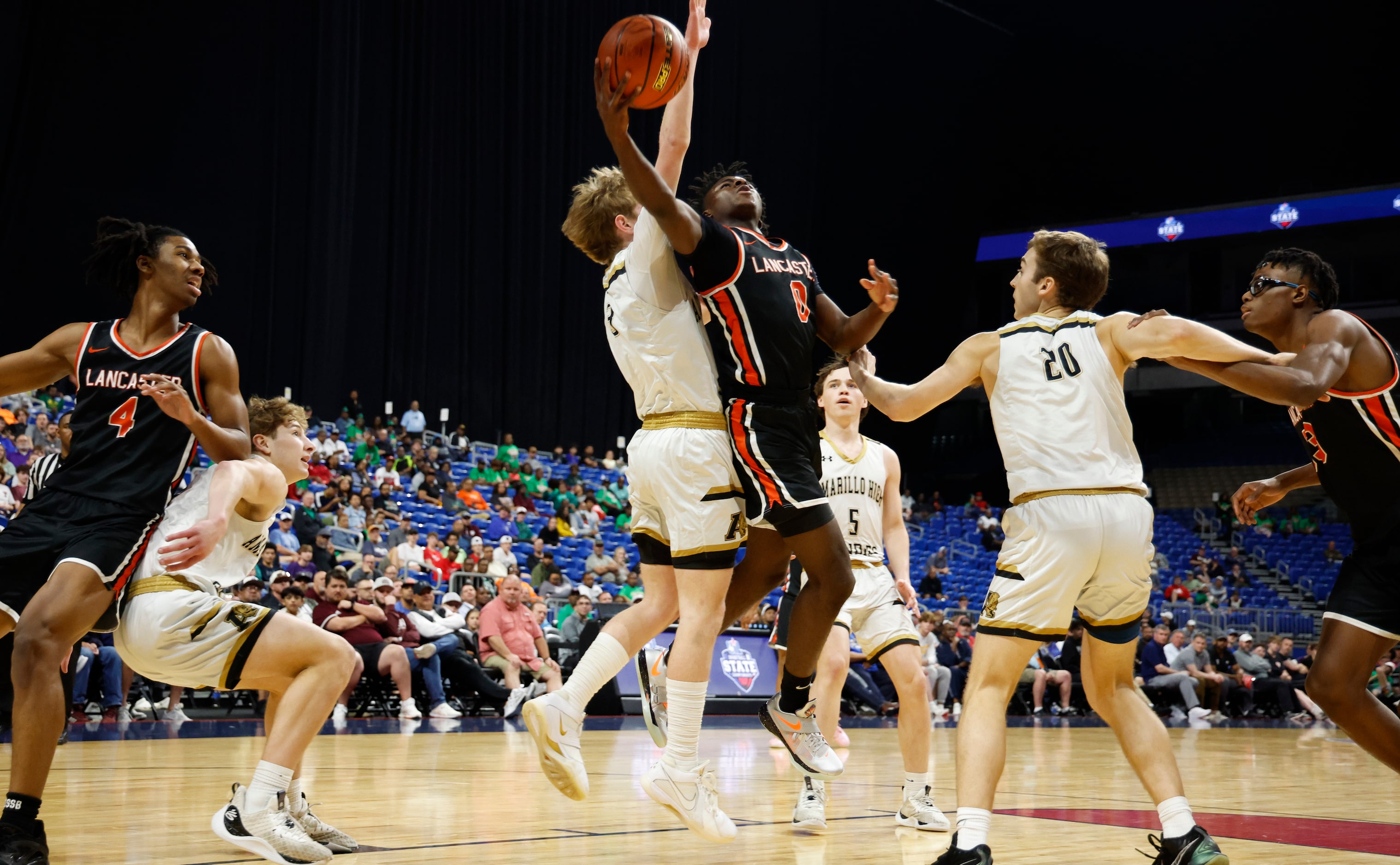 Lancaster's Des’Meon Jones (0) drives for the score in the first half of a boys basketball...