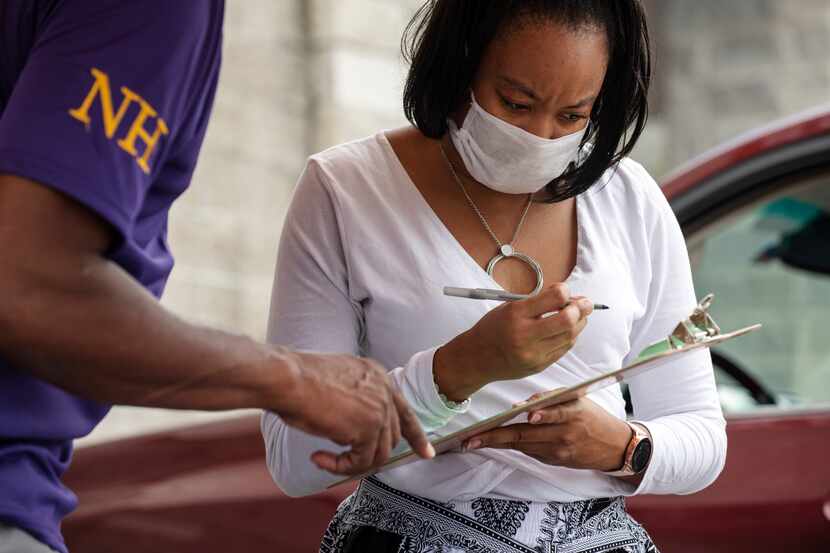 Hadassah Williams, 26, registers to vote during a voter registration drive outside of the...