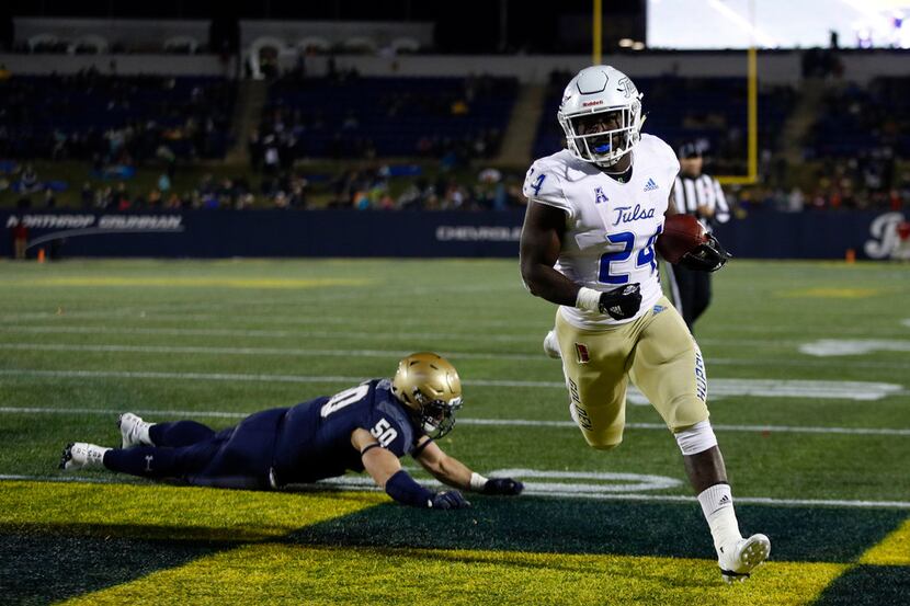 Tulsa running back Corey Taylor II scores a touchdown in front of Navy linebacker Diego...