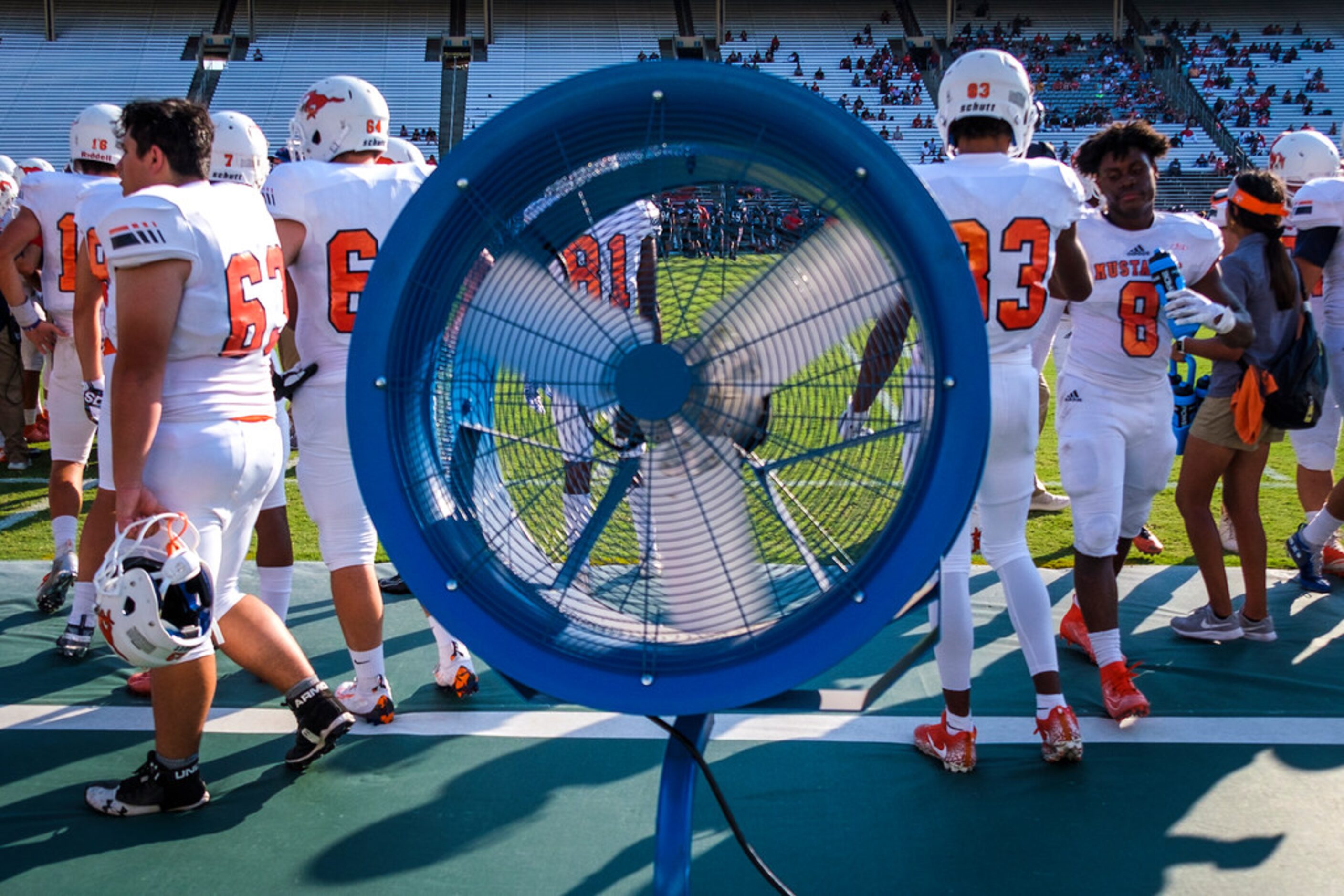 Fans cool the Sachse bench during the first half of a high school football game against...