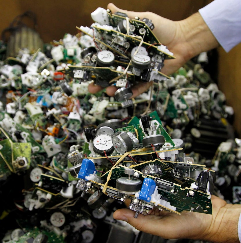 GameStop employee Bruce Kulp holds just a few of the thousands of game controllers that will...