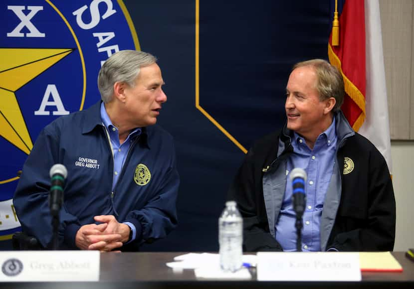 Texas Gov. Greg Abbott, left, and Texas Attorney General Ken Paxton during a Jan. 27...