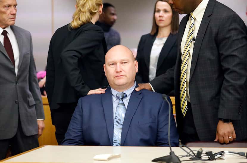 Former Dallas police officer Christopher Hess sits down after he was acquitted by a jury in...