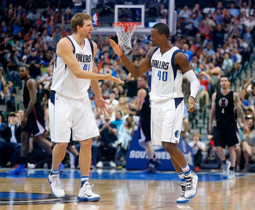 Dallas Mavericks forward Dirk Nowitzki (41) congratulates forward Harrison Barnes (40) on...