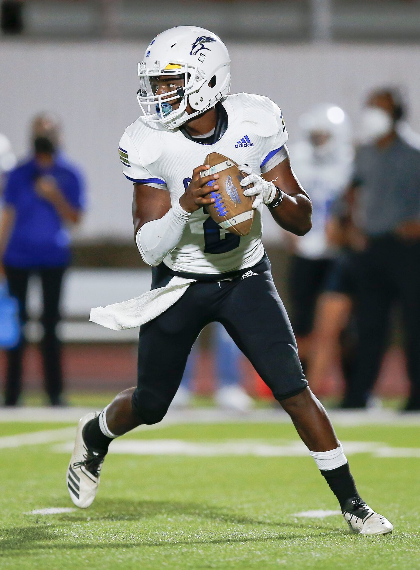 Conrad senior quarterback Chris Legard (2) looks for a receiver during the first half of a...