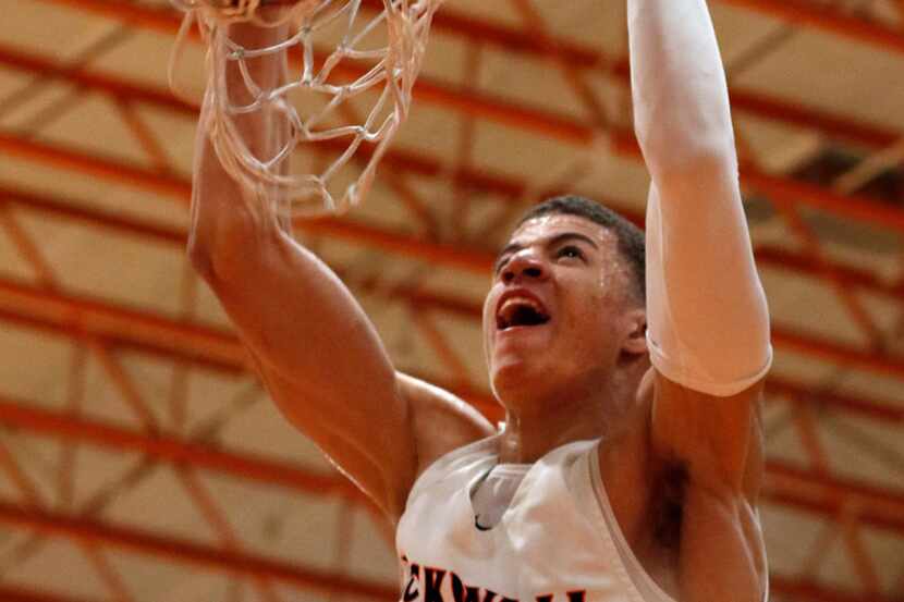 Rockwall's Samuell Williamson slams down a dunk during first-half action against...