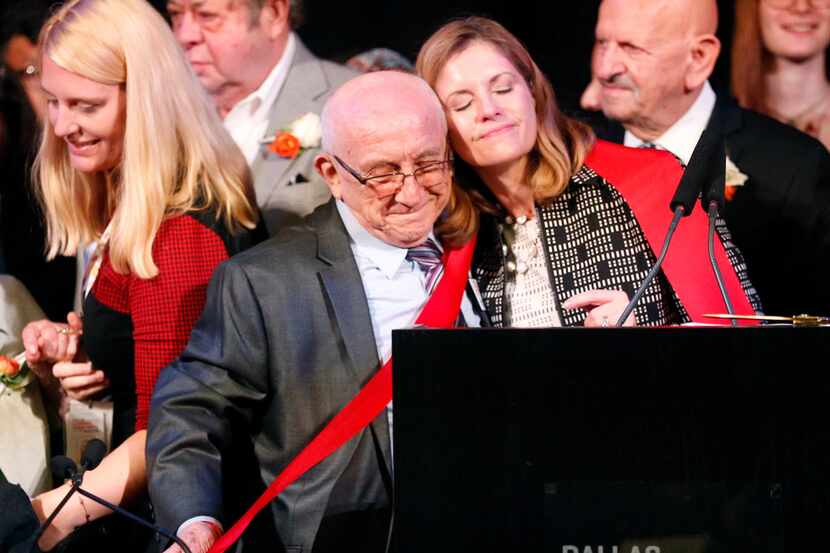 Museum CEO Mary Pat Higgins hugs Holocaust survivor Max Glauben on Tuesday after cutting a...