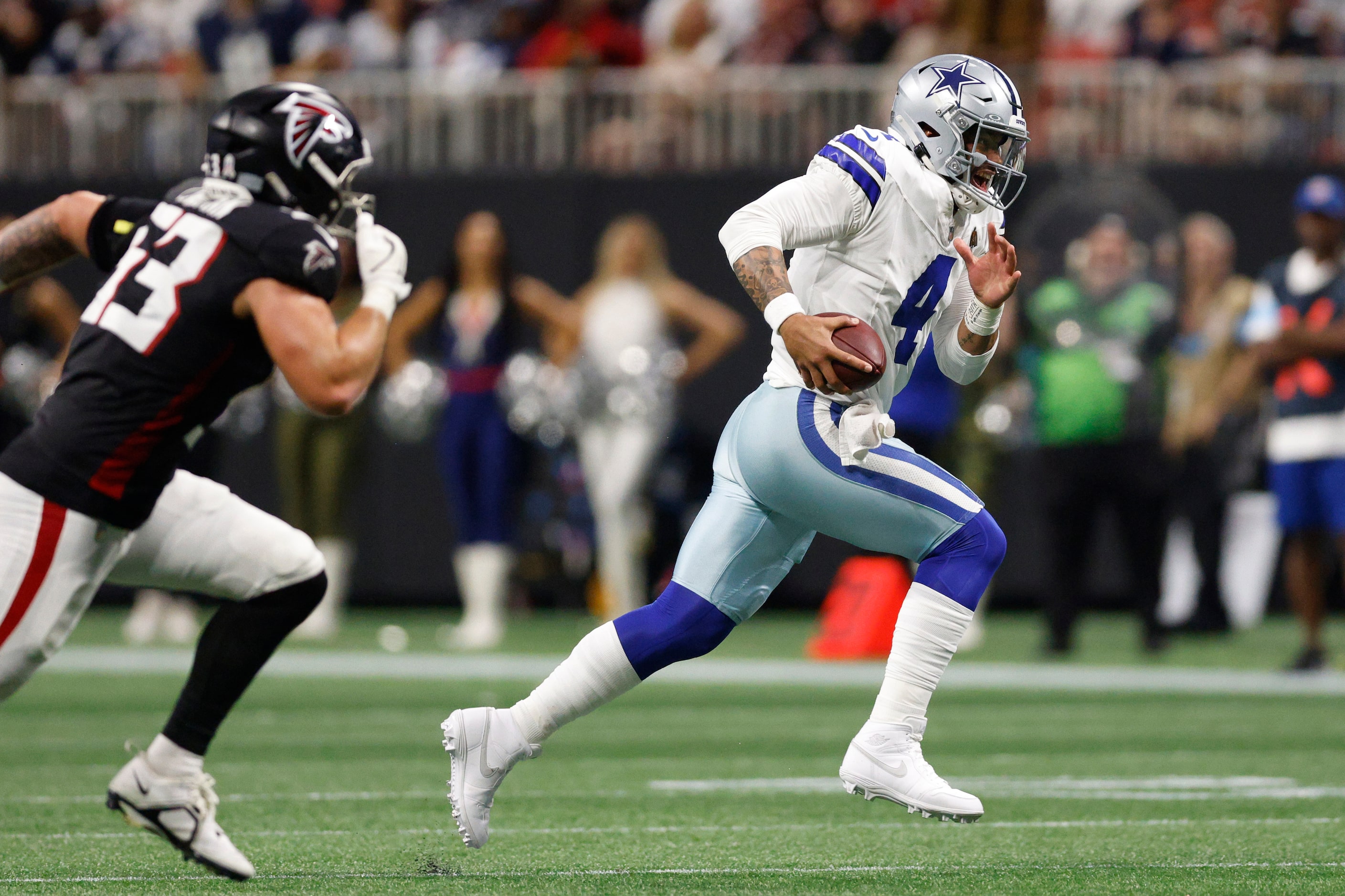 Dallas Cowboys quarterback Dak Prescott (4) scrambles for a first down during the first half...