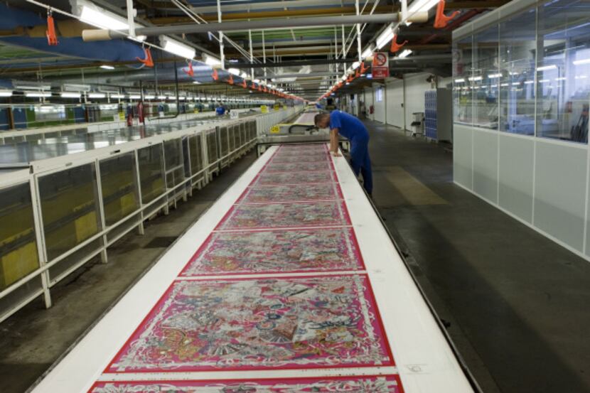 A continuous 160-meter stretch of silk twill will be cut and hand-hemmed into $60,000 worth...