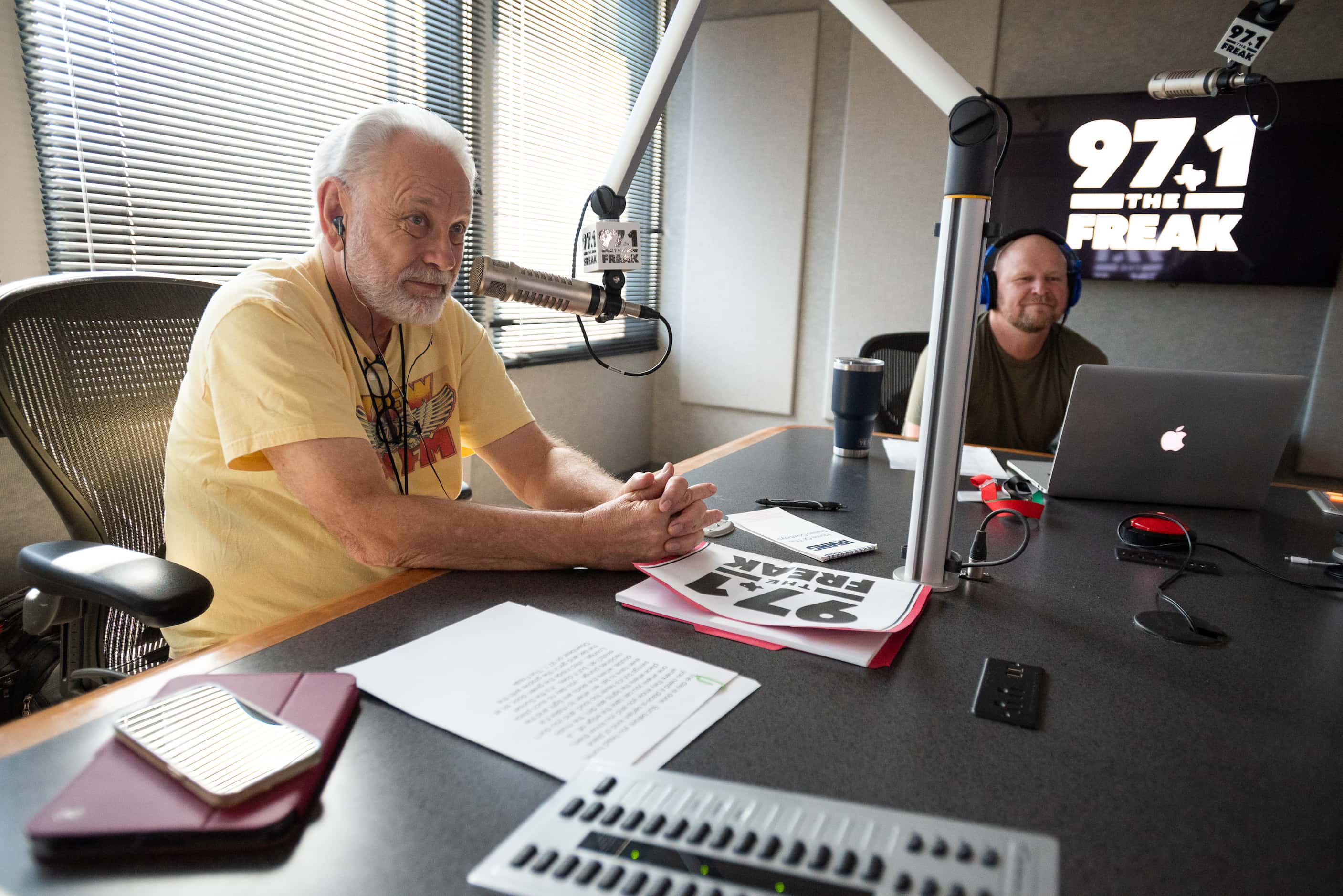 Mike Rhyner, left, and co-host Mike Sirois listen to the intro before they go live on the air.