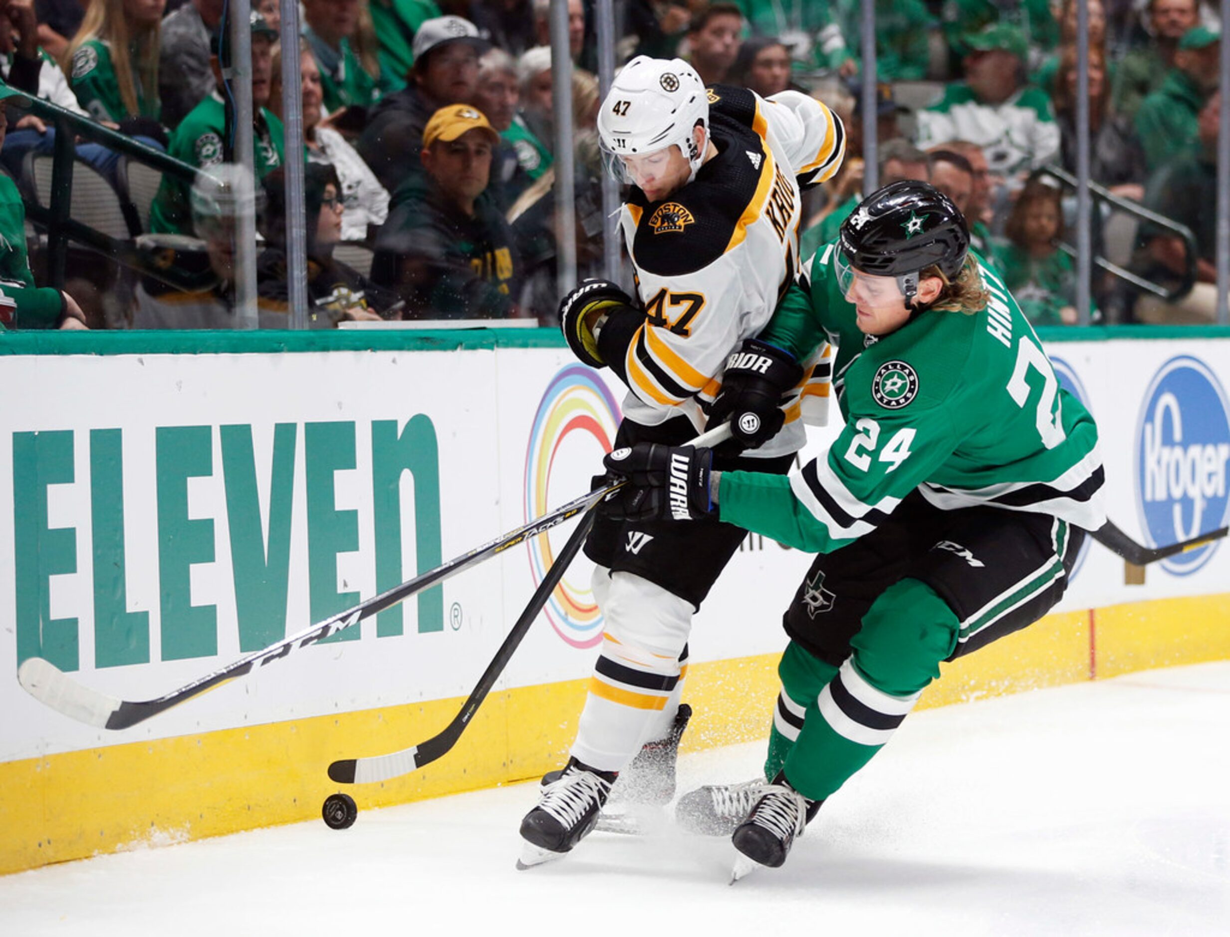 Boston Bruins defenseman Torey Krug (47) and Dallas Stars left wing Roope Hintz (24) go...