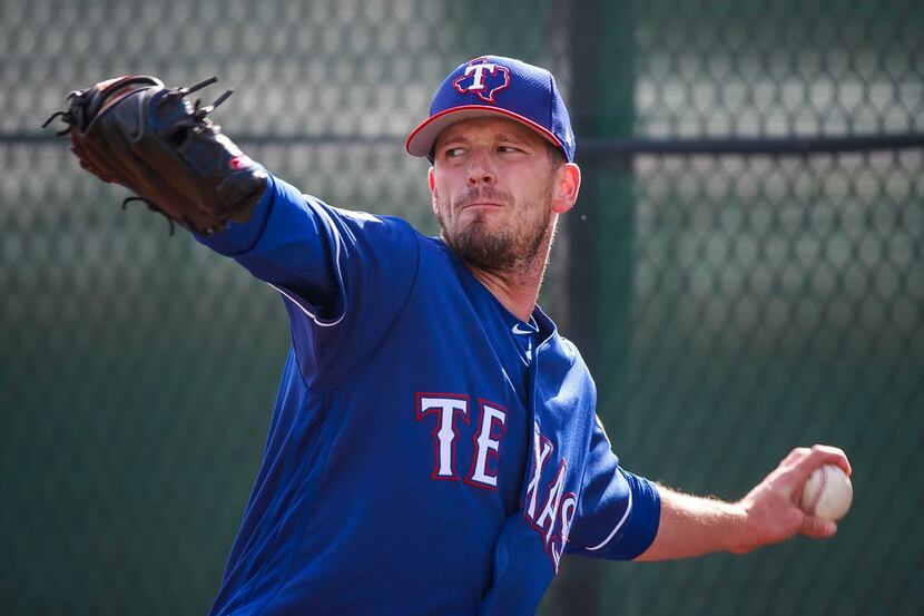 Texas Rangers pitcher Drew Smyly throws in the bullpen during a spring training workout at...