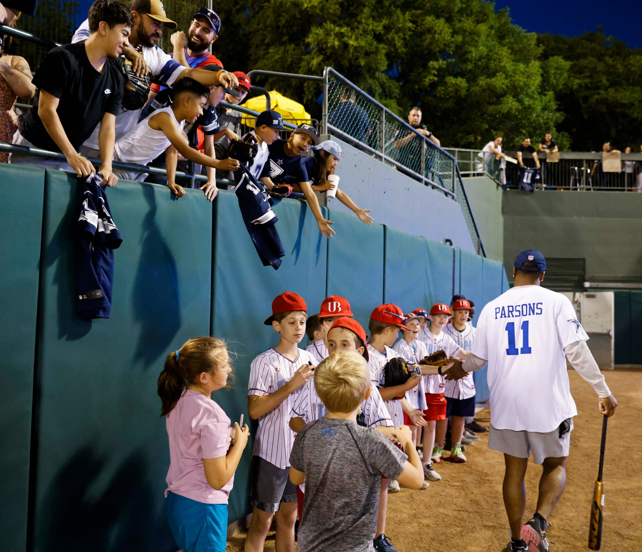 Dallas Cowboys linebacker Micah Parsons high fives young fans as he exits the field after...