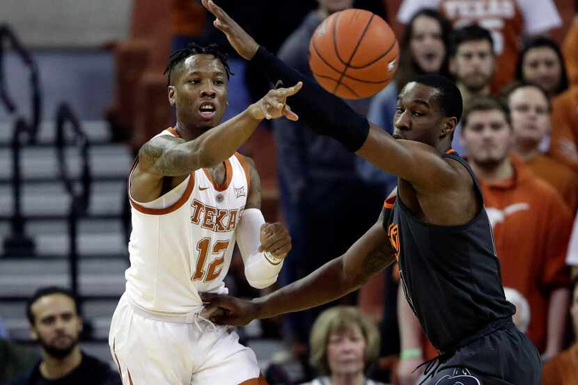 Texas guard Kerwin Roach II, left, passes the ball around Oklahoma State forward Cameron...