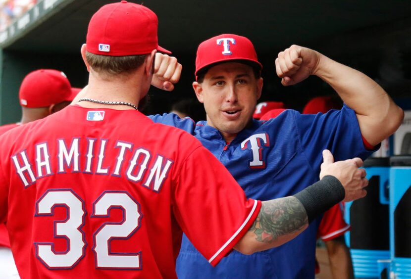 Texas Rangers left fielder Josh Hamilton (32) and pitcher Derek Holland (45) are pictured...