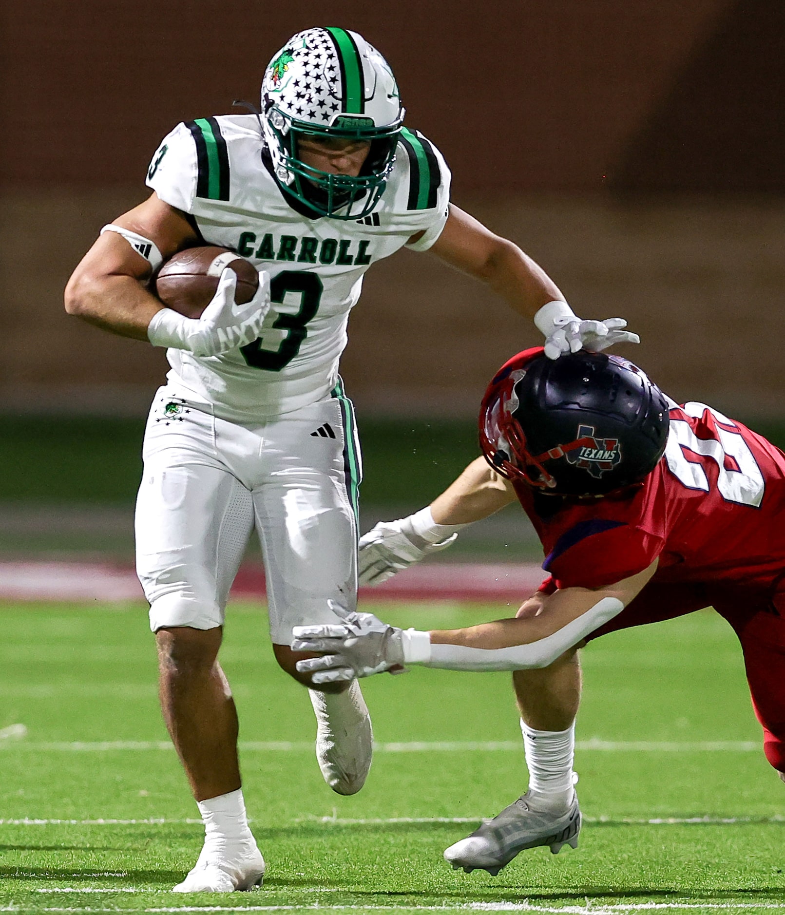 Southlake Carroll running back Davis Penn (3) tries to elude Justin Northwest defensive back...