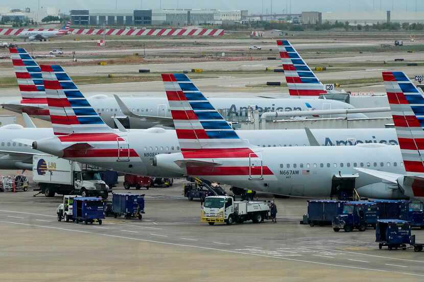 American Airlines planes are seen at the gates of Terminal C at DFW Airport on Sunday, Oct....