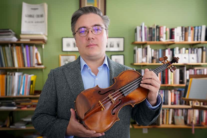 SMU professor Aaron Boyd poses with his violin on Thursday.