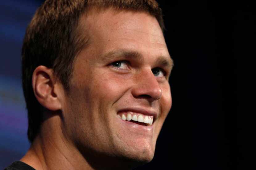 New England Patriots quarterback Tom Brady smiles during a media availability in Foxborough,...